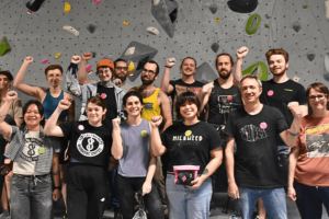 Rock climbing workers raise fists in solidarity